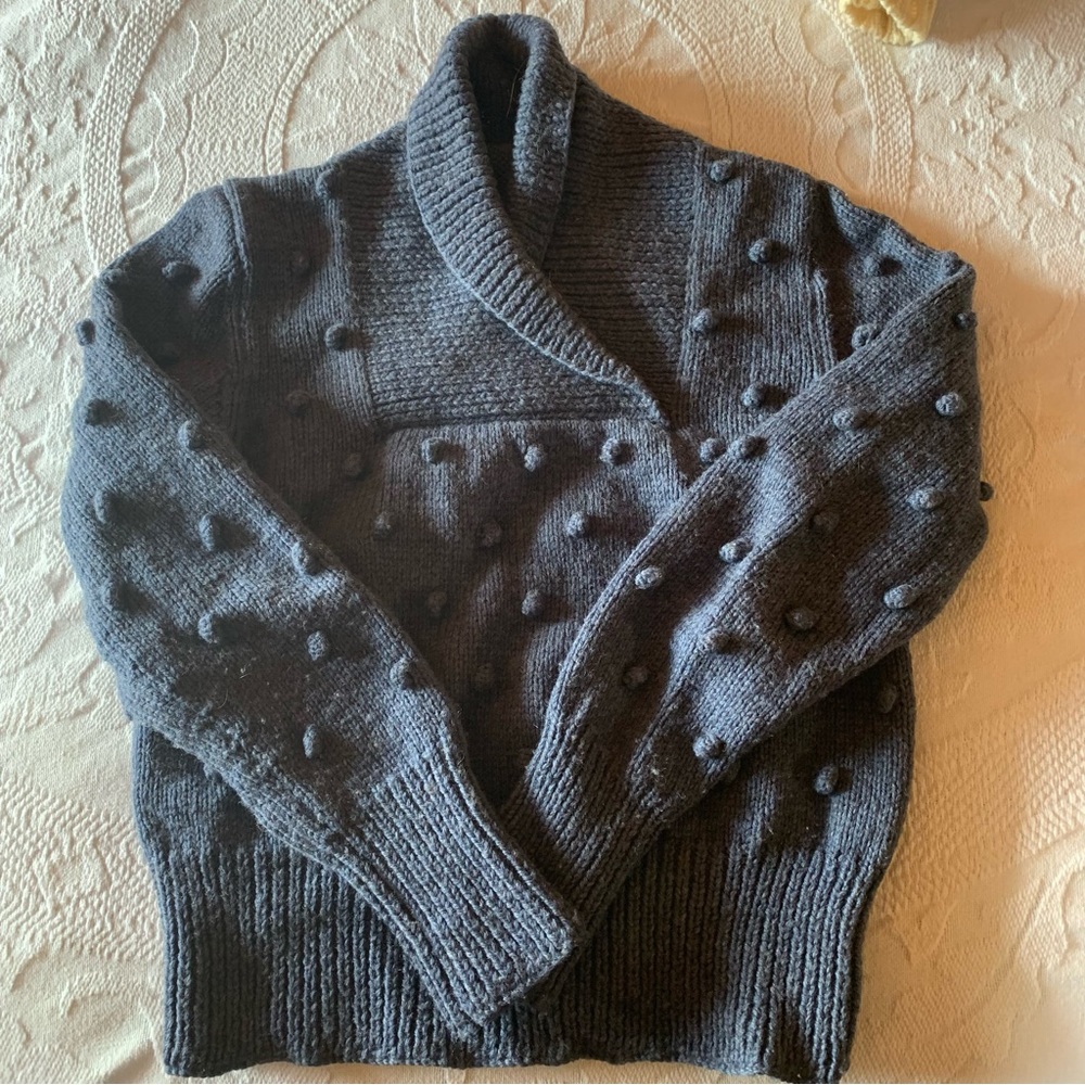 Popcorn- knit shawl-collar sweater.